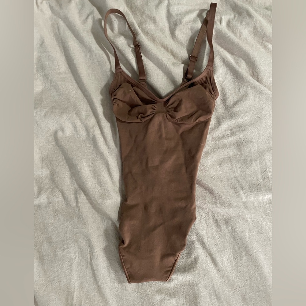 Skims Seamless sculpt thong bodysuit , color is “Jasper”
